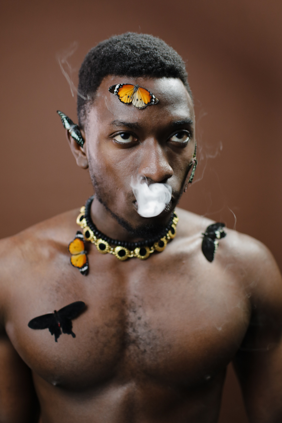 Man Wearing Black and Yellow Beaded Necklace