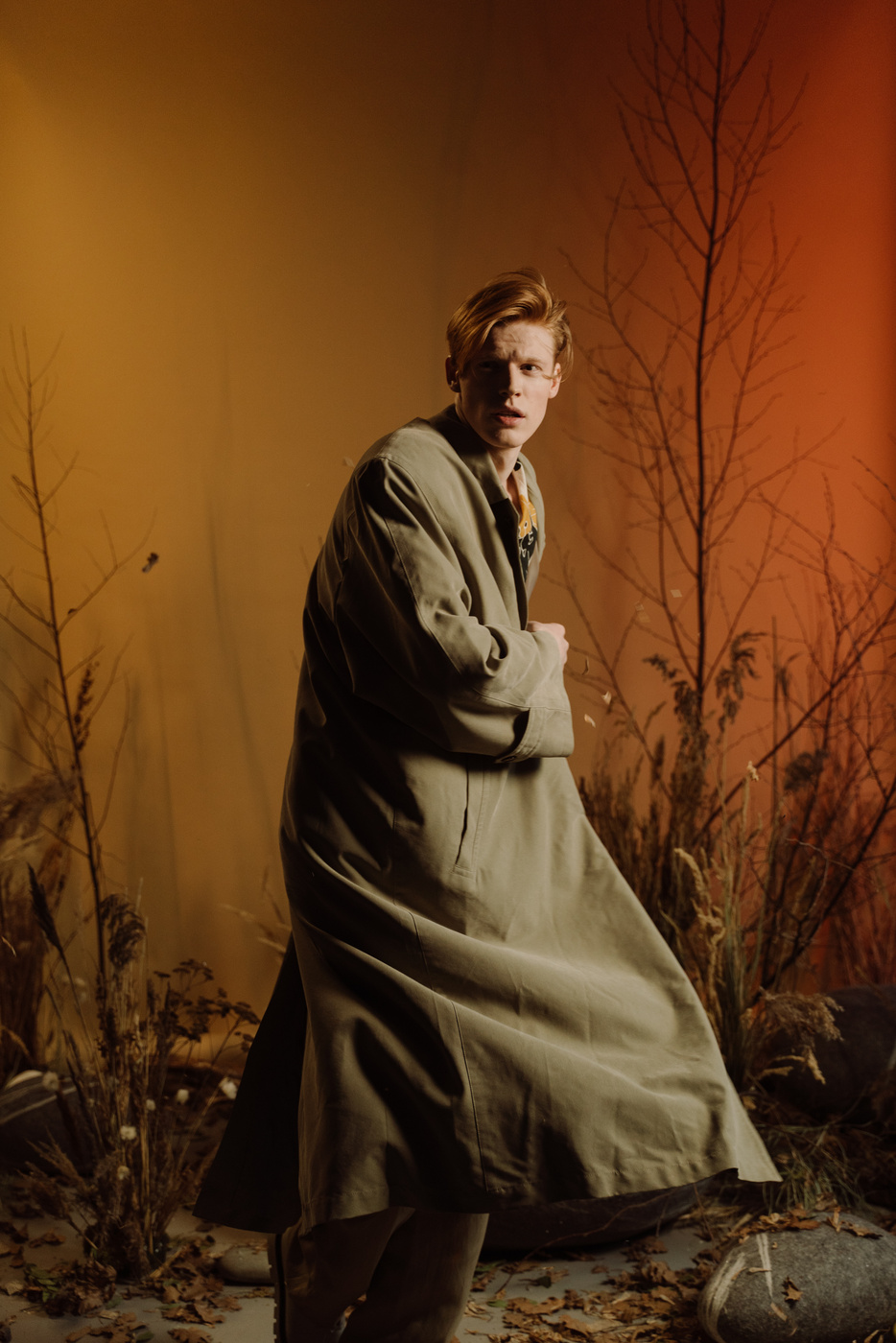 Man in White Robe Standing Near Brown Bare Tree