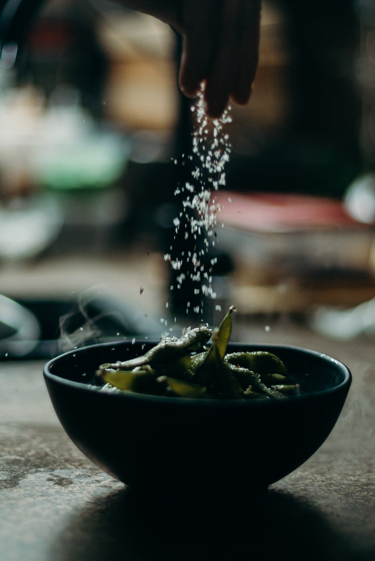 Salt Being Poured on Green Beans