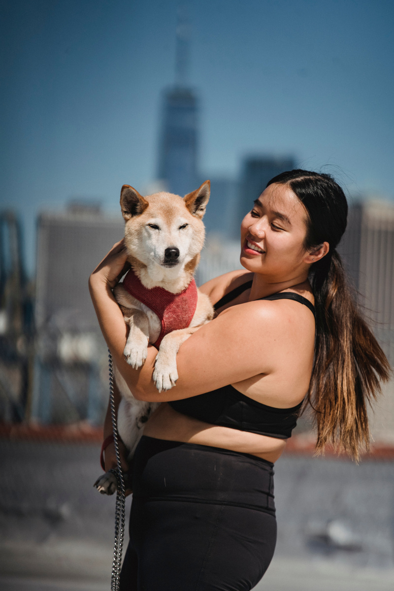 Smiling plus size Asian woman showing Shiba inu